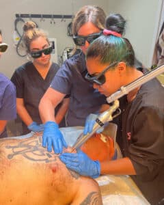 Laser tattoo removal students gaining hands-on experience.